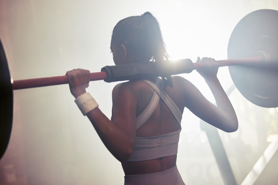 Woman lifting weights during a 3-day workout split